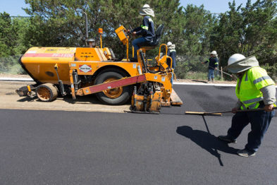 crew member setting asphalt